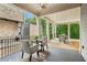 Spacious covered patio with an outdoor dining area and conversation area, overlooking a wooded area at 105 Cumming St, Alpharetta, GA 30009