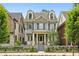 Charming two-story home with a landscaped yard, dormer windows, and a welcoming front porch at 105 Cumming St, Alpharetta, GA 30009