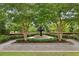 A classic water fountain surrounded by greenery with brick walls at 105 Cumming St, Alpharetta, GA 30009