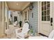 Inviting covered front porch featuring comfortable seating, stylish decor, and a welcoming ambiance at 105 Cumming St, Alpharetta, GA 30009
