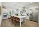 Gourmet kitchen with white cabinets, stainless steel appliances, large island, and bar stool seating at 105 Cumming St, Alpharetta, GA 30009
