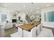 Open-concept living room and dining area with fireplace, wood floors, and ample natural light at 105 Cumming St, Alpharetta, GA 30009