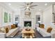 Bright living room with fireplace, hardwood floors, and stylish modern furnishings at 105 Cumming St, Alpharetta, GA 30009