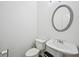 Bathroom features include a pedestal sink, toilet and mirror at 1636 Caswell Pkwy, Marietta, GA 30060
