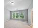 Neutral bedroom with light colored walls and carpet, natural light, and vaulted ceiling at 1636 Caswell Pkwy, Marietta, GA 30060
