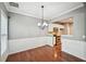 Dining room featuring wainscoting, hardwood floors, and a view into the modern kitchen at 1636 Caswell Pkwy, Marietta, GA 30060