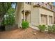 Beautiful brick townhome showcasing front porch, two-car garage, and lush green landscaping at 1636 Caswell Pkwy, Marietta, GA 30060