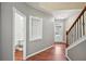 Inviting entryway featuring hardwood floors, a staircase, and a glimpse of the powder room at 1636 Caswell Pkwy, Marietta, GA 30060