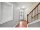 Warm and inviting hallway showcasing beautiful hardwood floors, a staircase, and natural light at 1636 Caswell Pkwy, Marietta, GA 30060