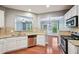 Modern kitchen featuring stainless steel appliances, granite countertops, and an open view of the living spaces at 1636 Caswell Pkwy, Marietta, GA 30060