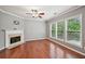 Bright living room with hardwood floors, a fireplace, and large windows offering ample natural light at 1636 Caswell Pkwy, Marietta, GA 30060