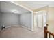 Carpeted living room with entryways to hallways and bedrooms in the home at 1636 Caswell Pkwy, Marietta, GA 30060
