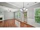 Spacious living area with fireplace, hardwood floors, and natural light from the adjacent windows at 1636 Caswell Pkwy, Marietta, GA 30060
