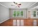 Bright and airy living room featuring hardwood floors, large windows, and a modern ceiling fan at 1636 Caswell Pkwy, Marietta, GA 30060