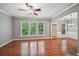 Spacious living room boasts hardwood floors, abundant natural light, and contemporary ceiling fan at 1636 Caswell Pkwy, Marietta, GA 30060