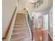 Elegant staircase featuring carpeted steps, wooden handrails, and access to multiple levels at 1636 Caswell Pkwy, Marietta, GA 30060