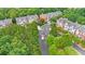 An aerial view of townhouses surrounded by lush green trees in a well-maintained community at 2988 Rivergreen Se Ln, Atlanta, GA 30339
