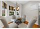 Breakfast nook with round table and chairs, lit by a stylish chandelier and natural light from bay windows at 2988 Rivergreen Se Ln, Atlanta, GA 30339