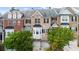 Charming brick townhome exterior showcases multi-story design, garage, and lush landscaping at 2988 Rivergreen Se Ln, Atlanta, GA 30339