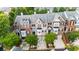 Aerial view showcases brick townhomes, mature trees, manicured lawns, and convenient parking at 2988 Rivergreen Se Ln, Atlanta, GA 30339