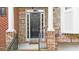 Front door and porch with brick columns, black hardware and storm door at 2988 Rivergreen Se Ln, Atlanta, GA 30339