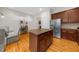 Kitchen featuring an island with granite counters, stainless steel appliances, and access to the breakfast nook at 2988 Rivergreen Se Ln, Atlanta, GA 30339