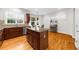 Well-lit kitchen featuring an island with granite countertops and storage, complemented by hardwood flooring at 2988 Rivergreen Se Ln, Atlanta, GA 30339