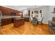A kitchen featuring wood cabinets, an island with granite counters, hardwood floors, and a breakfast nook with ample natural light at 2988 Rivergreen Se Ln, Atlanta, GA 30339