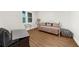 Cozy living room features stylish daybed, wood floors, and plenty of natural light from the picture window at 2988 Rivergreen Se Ln, Atlanta, GA 30339