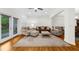Comfortable living room featuring hardwood floors, plush seating, and backyard access at 2988 Rivergreen Se Ln, Atlanta, GA 30339