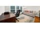 Bright office space features large windows, comfortable seating, and an elegant area rug at 2988 Rivergreen Se Ln, Atlanta, GA 30339