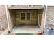An under-deck patio featuring brick and a door to the backyard at 2988 Rivergreen Se Ln, Atlanta, GA 30339