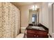 Cozy bathroom with floral shower curtain, dark wood vanity, and ample lighting at 3351 Cumberland Club Dr # 17, Atlanta, GA 30339