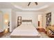 Inviting bedroom space featuring hardwood floors, tray ceiling and a ceiling fan at 3351 Cumberland Club Dr # 17, Atlanta, GA 30339