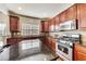 Spacious kitchen featuring granite counters, stainless steel appliances and beautiful wood cabinets at 3351 Cumberland Club Dr # 17, Atlanta, GA 30339