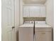 Well-lit laundry room with white washer and dryer at 3351 Cumberland Club Dr # 17, Atlanta, GA 30339