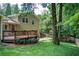 Exterior view of the backyard featuring a wooden deck and lush, mature trees at 4140 Candler Lake West Ne, Atlanta, GA 30319