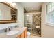 Updated bathroom with beautiful tiled shower, wooden vanity, and modern fixtures at 4140 Candler Lake West Ne, Atlanta, GA 30319