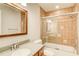 Bathroom with tub and shower combo, tile surround, glass doors, and granite countertops at 4140 Candler Lake West Ne, Atlanta, GA 30319