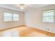 Sunlit bedroom with hardwood floors, ceiling fan, and two windows at 4140 Candler Lake West Ne, Atlanta, GA 30319