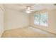 Cozy bedroom with neutral carpet, fan, and natural light from the multiple windows at 4140 Candler Lake West Ne, Atlanta, GA 30319