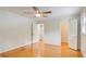 Bright bedroom featuring hardwood floors, ceiling fan, and a doorway that leads to a hallway at 4140 Candler Lake West Ne, Atlanta, GA 30319