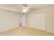 Bedroom with neutral carpet, ceiling fan, large closets, and view to another room at 4140 Candler Lake West Ne, Atlanta, GA 30319