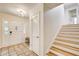 Bright foyer with tile flooring, staircase, closet, and glass-paned front door at 4140 Candler Lake West Ne, Atlanta, GA 30319