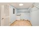 Functional laundry room featuring tile flooring, utility sink, and shelving for storage at 4140 Candler Lake West Ne, Atlanta, GA 30319