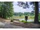 Scenic view of the pond with a bench, little free library, and peaceful surroundings at 4140 Candler Lake West Ne, Atlanta, GA 30319