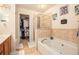 Inviting bathroom with a soaking tub, walk-in shower, and closet space, designed for relaxation and comfort at 461 Mountain View Ln, Woodstock, GA 30188