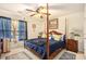 Cozy bedroom with a four-poster bed, ceiling fan, and natural light, creating a relaxing and inviting atmosphere at 461 Mountain View Ln, Woodstock, GA 30188