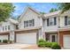 Beautiful exterior of a townhome with a two-car garage and inviting front porch at 461 Mountain View Ln, Woodstock, GA 30188