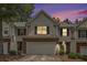 Charming townhouse with a two-car garage, brick accents, and manicured landscaping at 461 Mountain View Ln, Woodstock, GA 30188